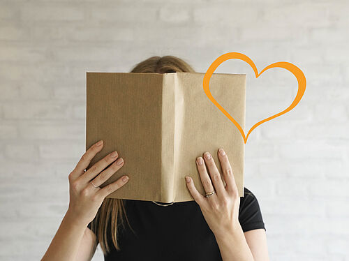 Billede af bibliotekar med en bog i hånden